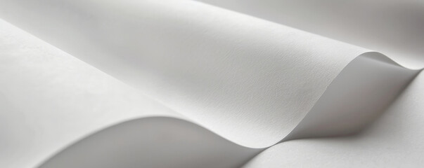 A detailed view of smooth, white printer paper with a fine, even texture. The clean, crisp surface reflects light softly, highlighting its pristine appearance.