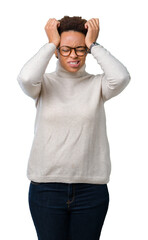 Fototapeta premium Young beautiful african american woman wearing glasses over isolated background suffering from headache desperate and stressed because pain and migraine. Hands on head.