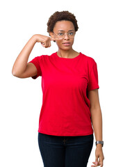 Beautiful young african american woman wearing glasses over isolated background Pointing with hand finger to face and nose, smiling cheerful