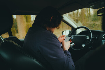 Caucasian man driver using mobile phone while stoppedю