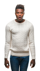 Fototapeta premium Young african american man over isolated background afraid and shocked with surprise expression, fear and excited face.