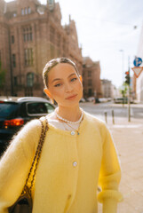 Portrait of young attractive woman fashion model posing outdoor at city street .