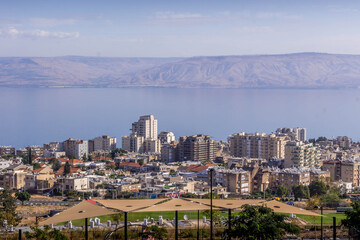 The panorama view of Tiberias, the Israeli city on the Sea of Galilee, with modern houses, the Lake, and the Golan Heights, in Israel.
