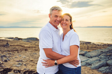 Happy Romantic Mature Couple Enjoying Sunset on the Beach