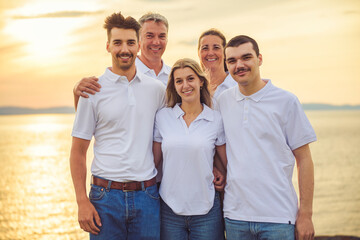 big family at beach on summer time, relax and support. Sunset, nature and smile with parents, kids walking by the sea for vacation