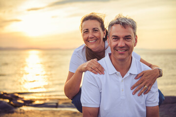 Happy Romantic Mature Couple Enjoying Sunset on the Beach
