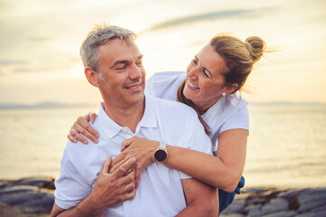 Happy Romantic Mature Couple Enjoying Sunset on the Beach