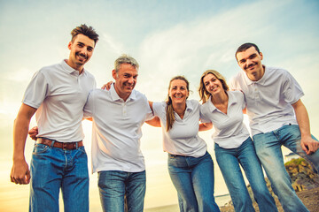 big family at beach on summer time, relax and support. Sunset, nature and smile with parents, kids walking by the sea for vacation