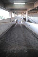 Empty parking deck with ramp in underground basement parking building