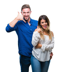 Young couple in love over isolated background smiling doing phone gesture with hand and fingers like talking on the telephone. Communicating concepts.