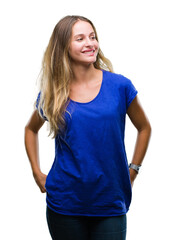 Fototapeta premium Young beautiful blonde woman over isolated background looking away to side with smile on face, natural expression. Laughing confident.