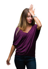 Young beautiful blonde elegant woman over isolated background surprised with hand on head for...