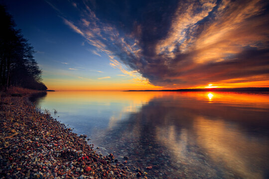 Dramatic sunset over a pebble beach and the Curonian Gulf, Lithuania