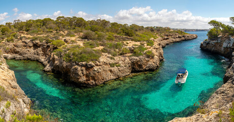 Aerial view of boat sailing in a cove, Cala Beltran, Llucmajor, Majorca, Balearic Islands, Spain