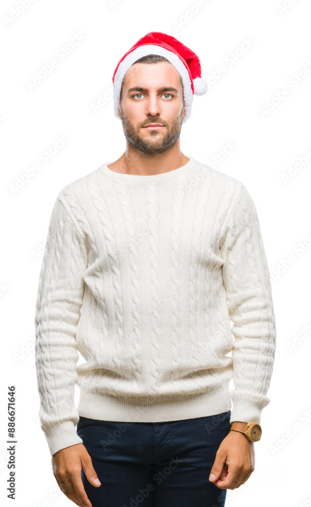 Poster Young handsome man wearing santa claus hat over isolated background with serious expression on face. Simple and natural looking at the camera.