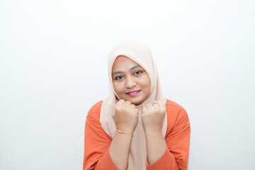 Portrait of a beautiful young Asian Muslim woman wearing a hijab being photographed in a studio