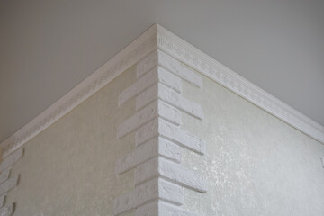 Detail of corner ceiling cornice with intricate crown moulding.