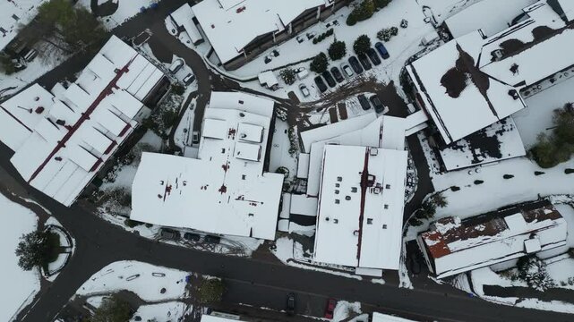hotel building resort winter snow covered topdown aerial drone shot circling above skiing holiday season
