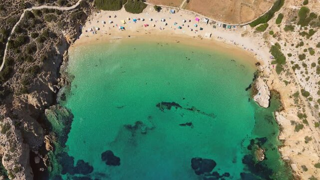 A stunning aerial perspective of famous Kedros Beach on Donousa Island in the Cyclades, Greece. The turquoise waters gently lap against the golden sands.