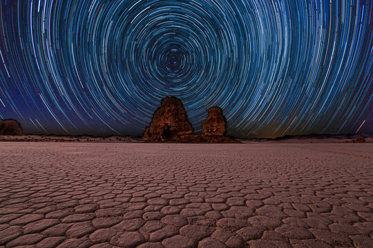 Star trail over a desert landscape at night, Saudi Arabia