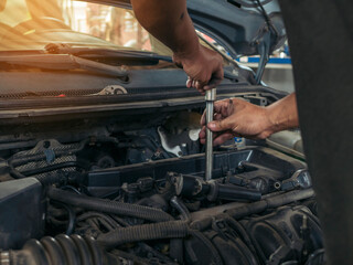 Close up Man hands fixing Car machinery vehicle mechanical service. Mechanic man hands repairing car auto repair shop. open vehicle hood checking up auto mobile. Vehicle Car maintenance engineer.