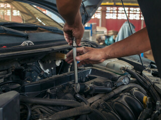 Close up Man hands fixing Car machinery vehicle mechanical service. Mechanic man hands repairing...