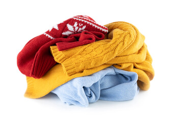Crumpled knitted clothes isolated on white, colorful woolen clothing pile.Autumn winter apparel,laundry.