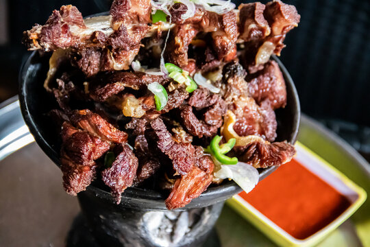 Shekla Tibs is a savory Ethiopian national meal of sauted meat and spices, traditionally served in a clay pot with injera
