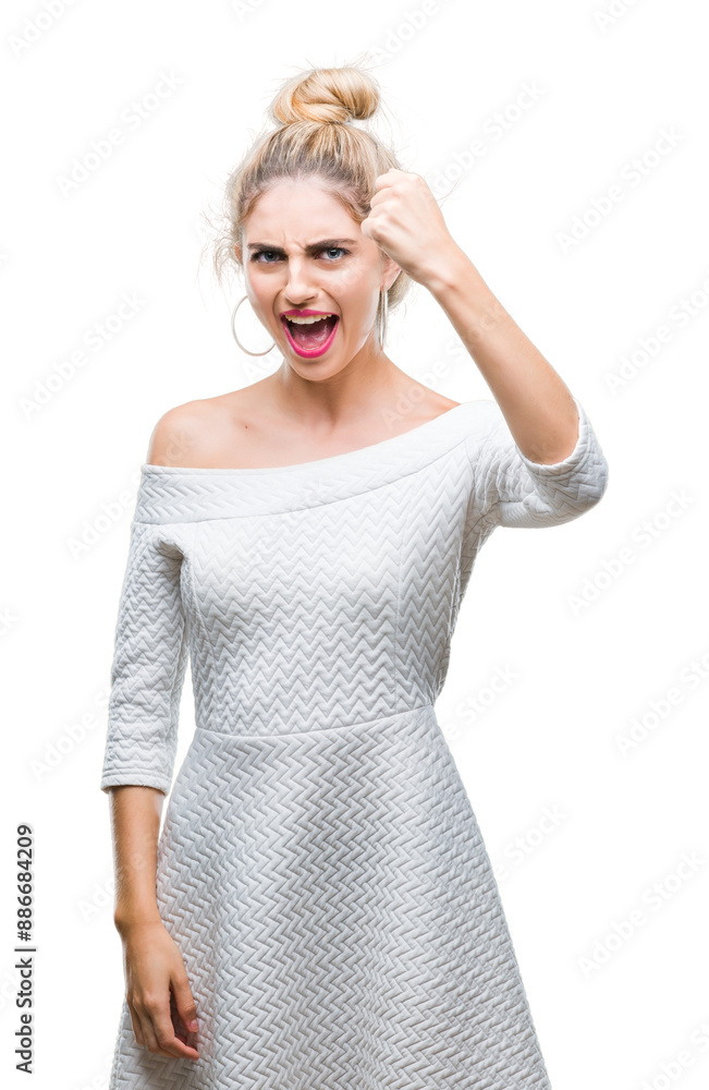 Sticker Young beautiful blonde and blue eyes woman over isolated background angry and mad raising fist frustrated and furious while shouting with anger. Rage and aggressive concept.