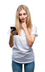 Young beautiful blonde woman using smartphone over isolated background serious face thinking about question, very confused idea