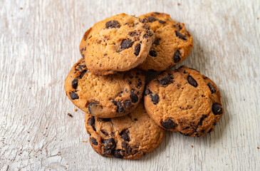 Chocolate chip cookies on wooden table. Selective focus, shallow depth of field.
