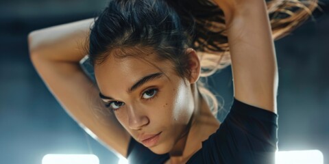 Fototapeta premium A woman holds a tennis racquet, ready to play