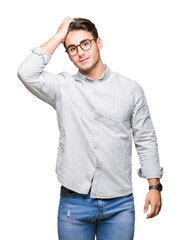 Young handsome man wearing glasses over isolated background Smiling confident touching hair with hand up gesture, posing attractive