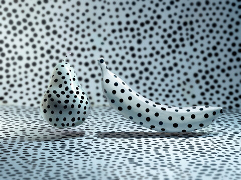 Black and white polka dot banana and pear against a polka dot background