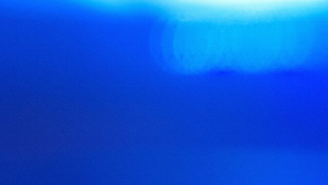 Abstract background Flat style. Freeform blue gradient color background with defocused blur and noise effects. Light and dark blue colors copy space text area. White circle light