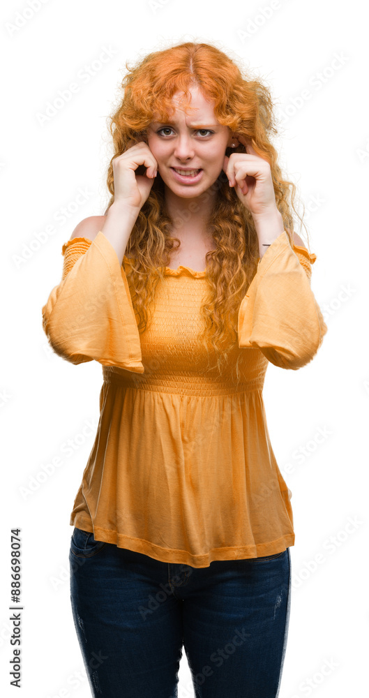 Poster young redhead woman covering ears with fingers with annoyed expression for the noise of loud music. 