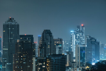 Night city skyline with high-rise buildings and skyscrapers in Kuala Lumpur, Malaysia. Downtown financial and business center of Asian city with modern architecture. Travel and tourism background