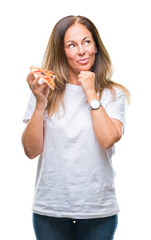 Middle age hispanic woman eating pizza slice over isolated background serious face thinking about question, very confused idea