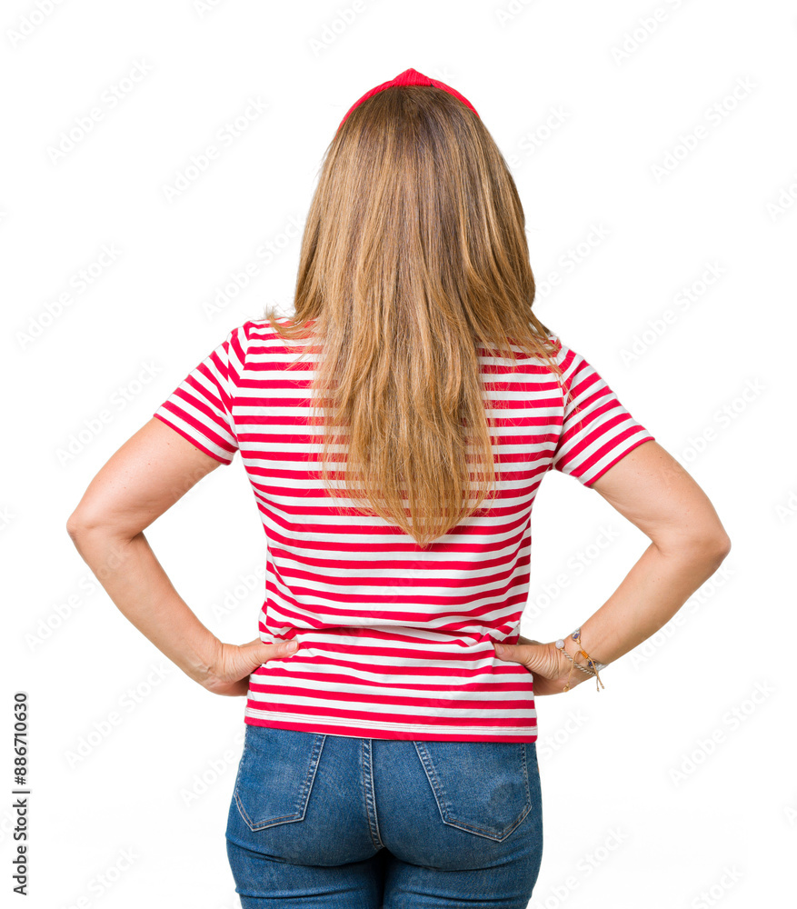 Wall mural beautiful middle age woman wearing casual stripes t-shirt over isolated background standing backward