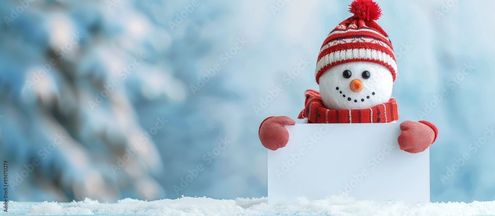 Poster snowman happily positioned behind a blank greeting card in a photograph with ample empty space for t