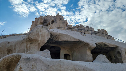 A cave in the castle in the rock, through which tourists walk