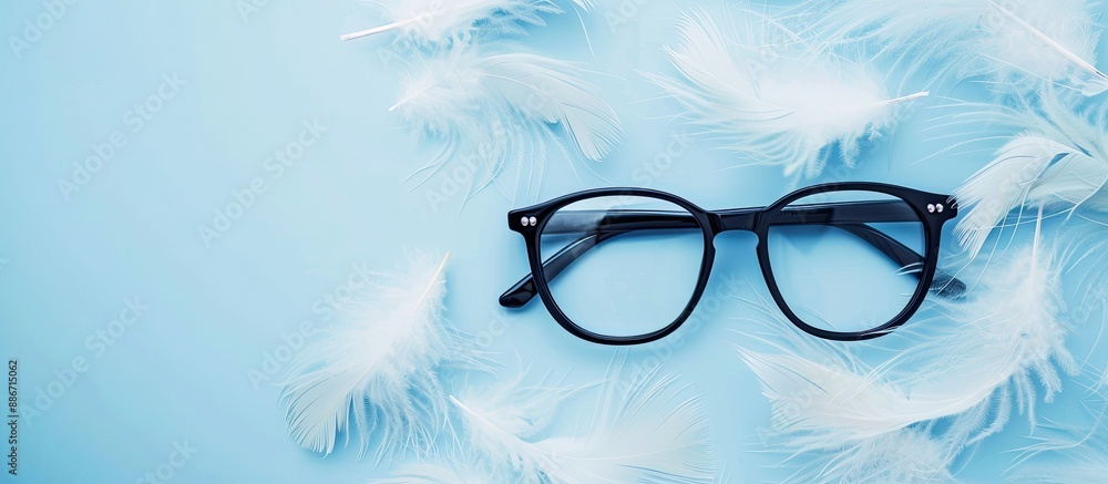Poster a pair of black framed glasses rests on white feathers against a blue backdrop with excess space sui