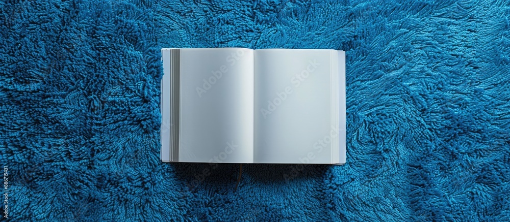 Poster white paper with open book on blue carpet background featuring symmetry and copy space image