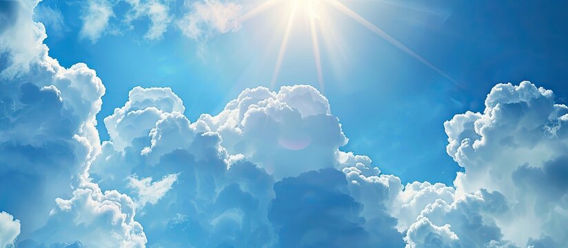 Sunny summer sky with light curly white clouds floating in a bright blue background symbolizing heaven and infinity ideal as a copy space image