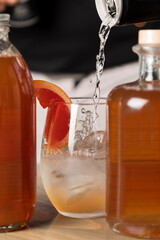 Tonic being poured into a gin cocktail
