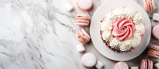 Fototapeta premium Sumptuous cake garnished with macarons and marshmallows beside tea on a white marble table with a stunning copy space image