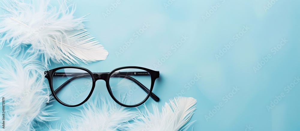 Poster a pair of black framed glasses rests on white feathers against a blue backdrop with excess space sui