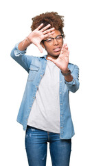 Beautiful young african american woman wearing glasses over isolated background Smiling doing frame using hands palms and fingers, camera perspective