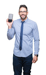 Young business man showing smartphone screen over isolated background with a happy face standing and smiling with a confident smile showing teeth