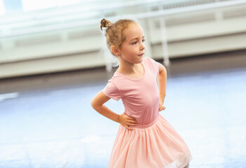 Cute little ballerina having fun on ballet room